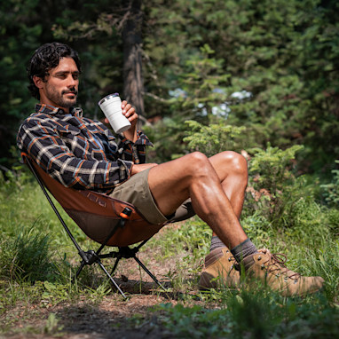 Person resting in the Wren compact chair outdoors