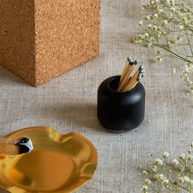 gold cylindrical container with matches