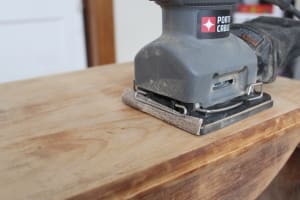 An orbital sander saves you a lot of effort. Bite the bullet and buy one, or you'll wish you did when you're an hour into sanding by hand.