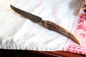 An ancient fixed blade with an antler handle. It was a gift from my grandfather.